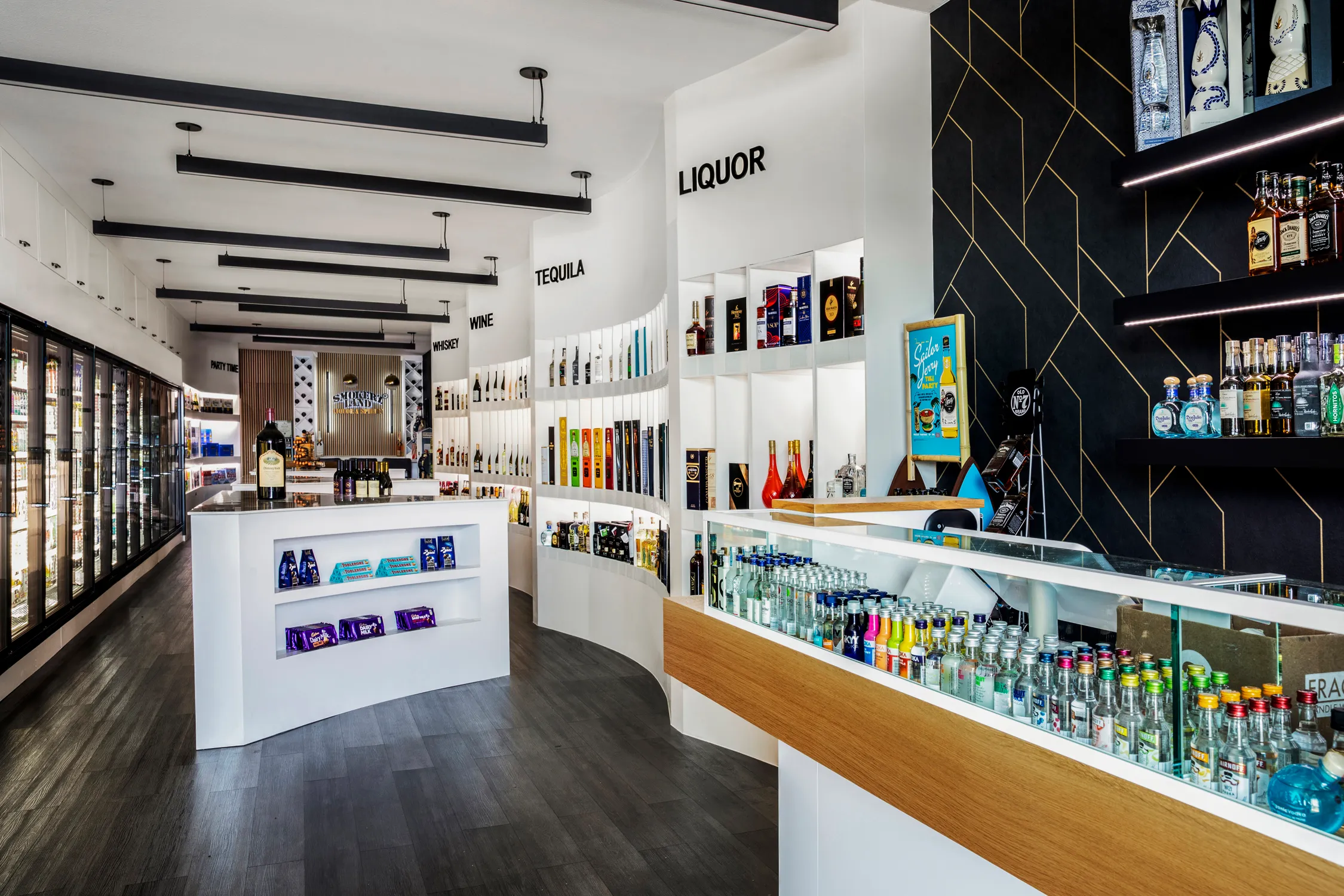 Liquor store interior with white sales counter and bottle displays