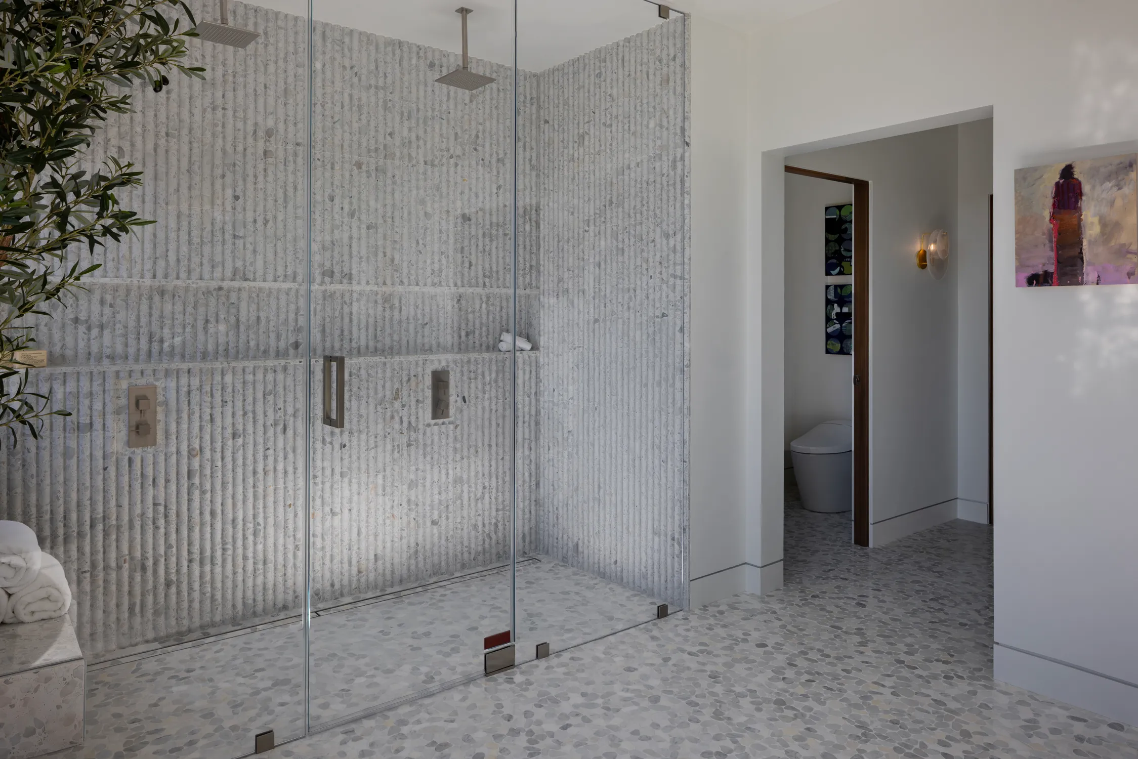 Glass shower with vertical gray wall tile