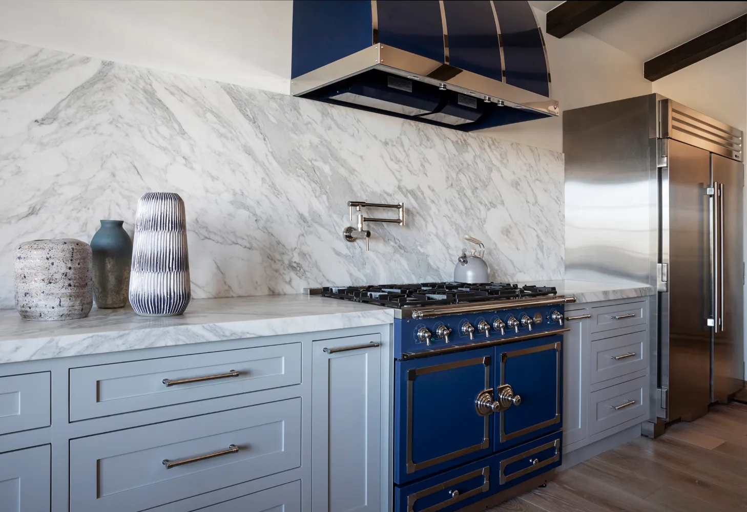 Gray range wall with marble backsplash and blue range