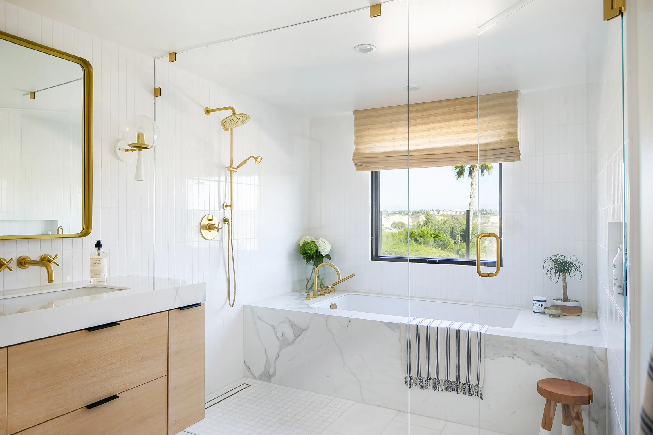 Bright bathroom with freestanding tub and brass fixtures
