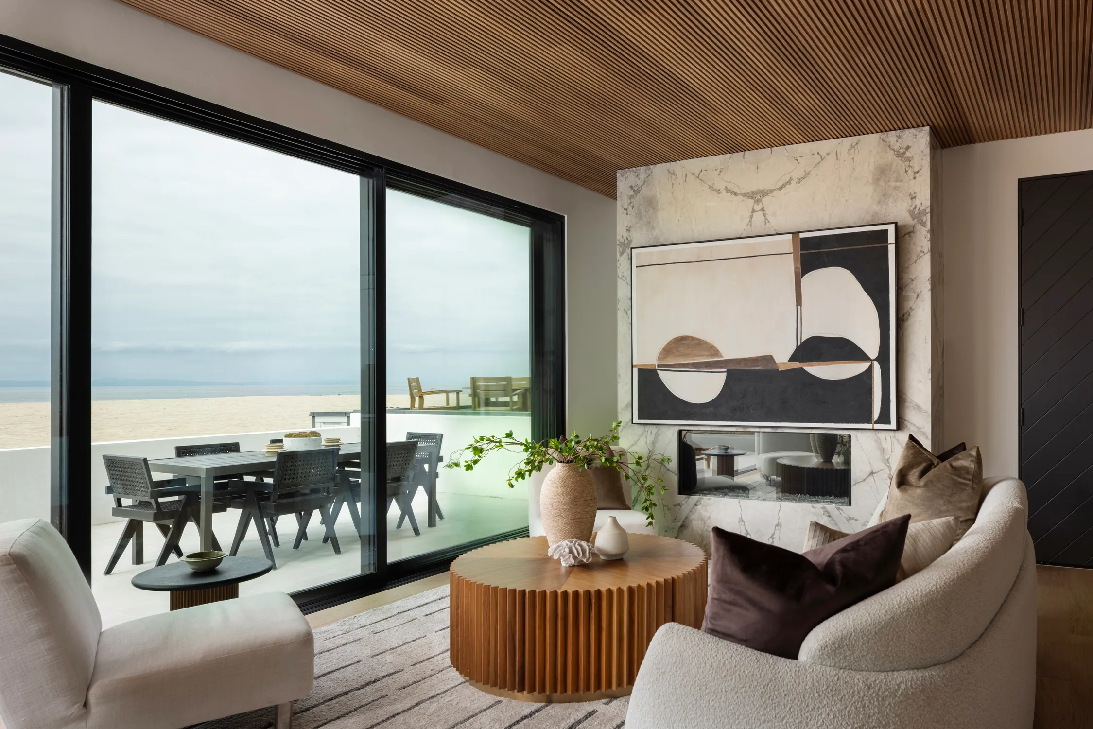 Ocean-view living room with wood ceiling and sliding doors