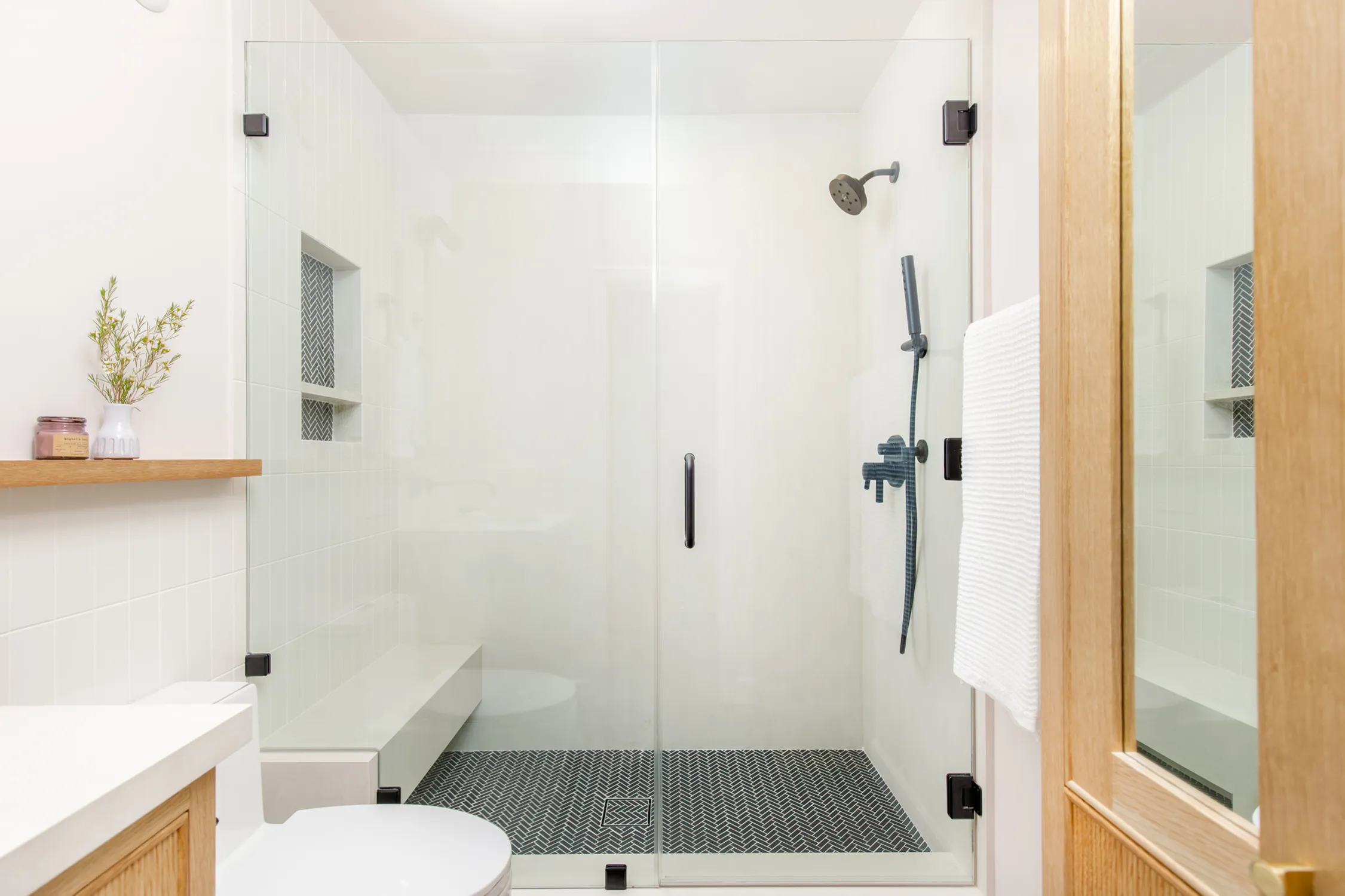 White tiled shower with black hardware