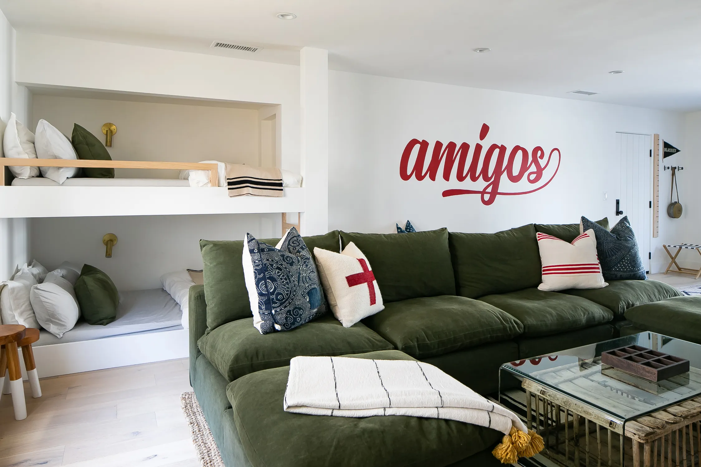 Living room with green sectional and built-in bench seating