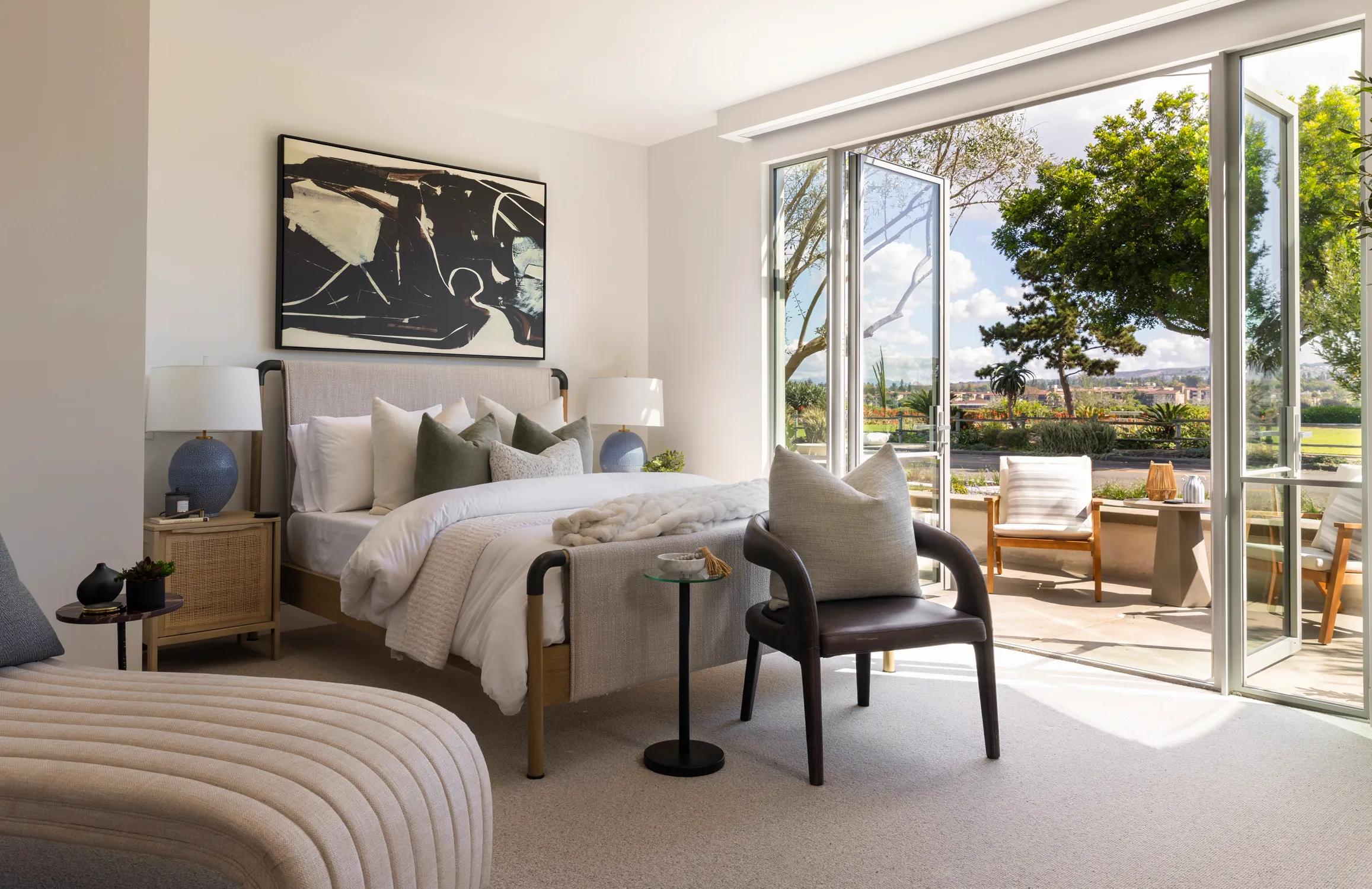 Bedroom with open glass doors to a patio