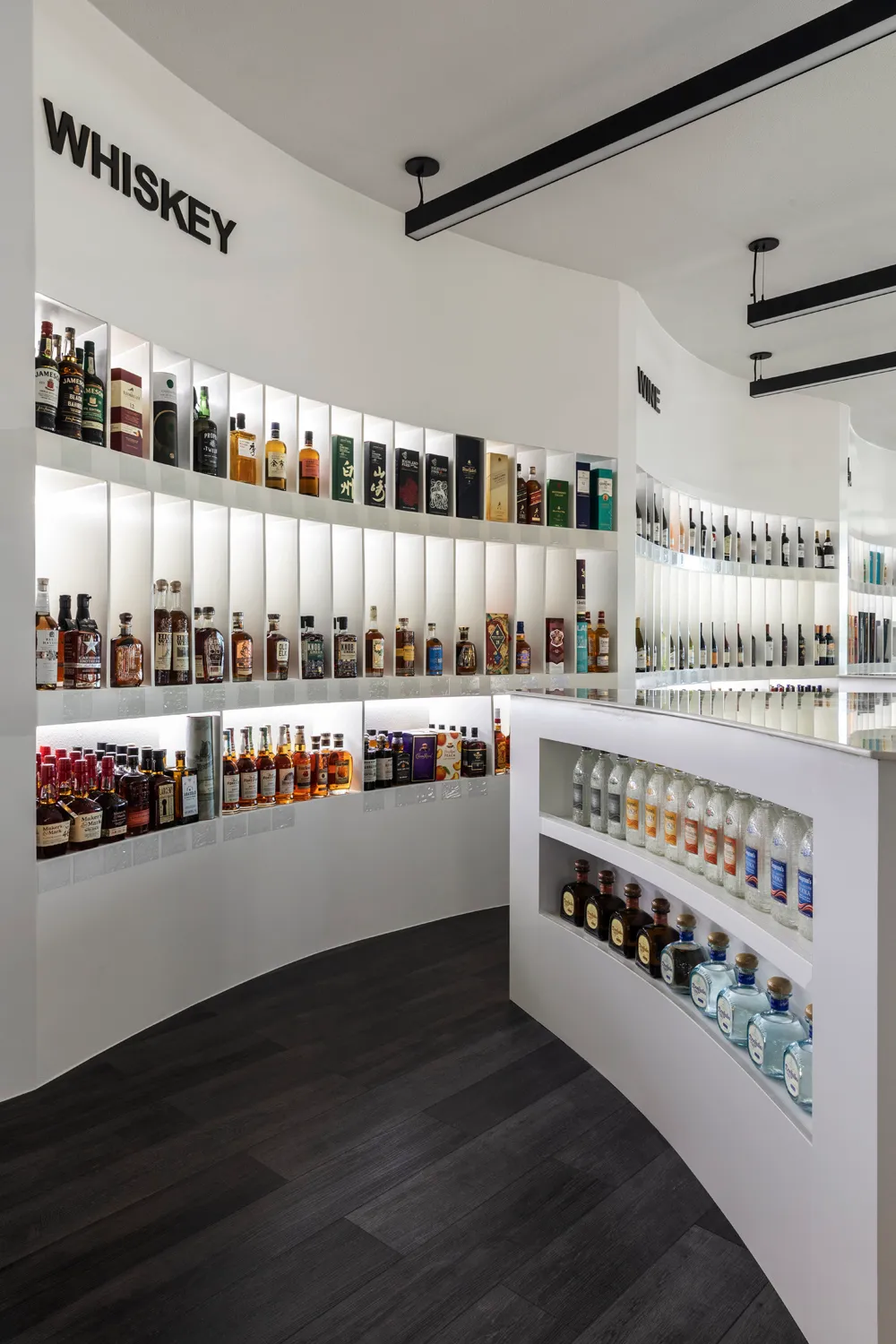 Modern liquor store interior with illuminated bottle displays