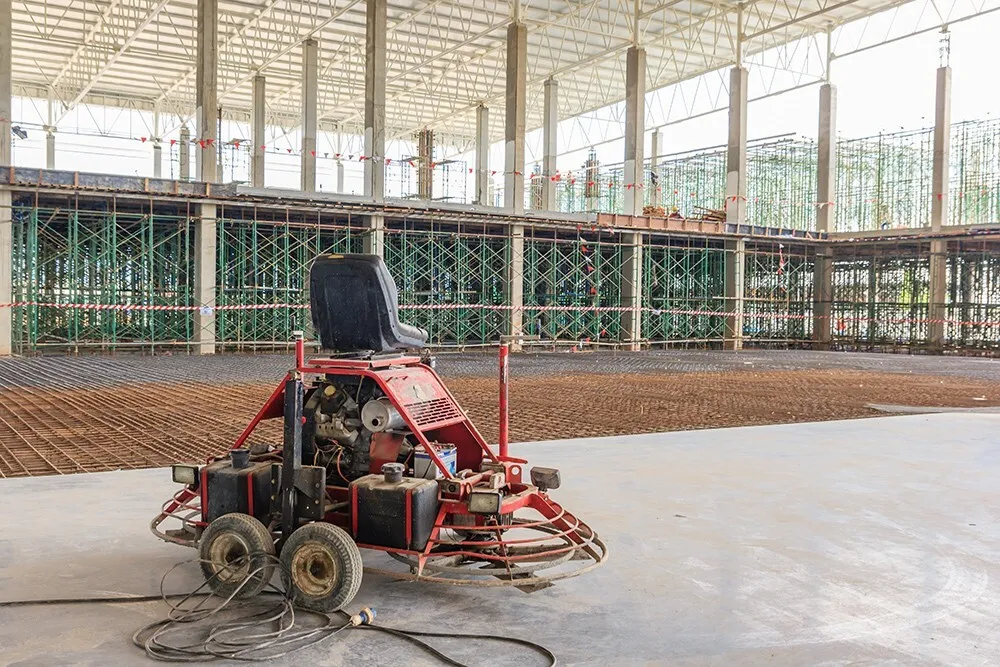 Floor-preparation machine in an industrial building under construction