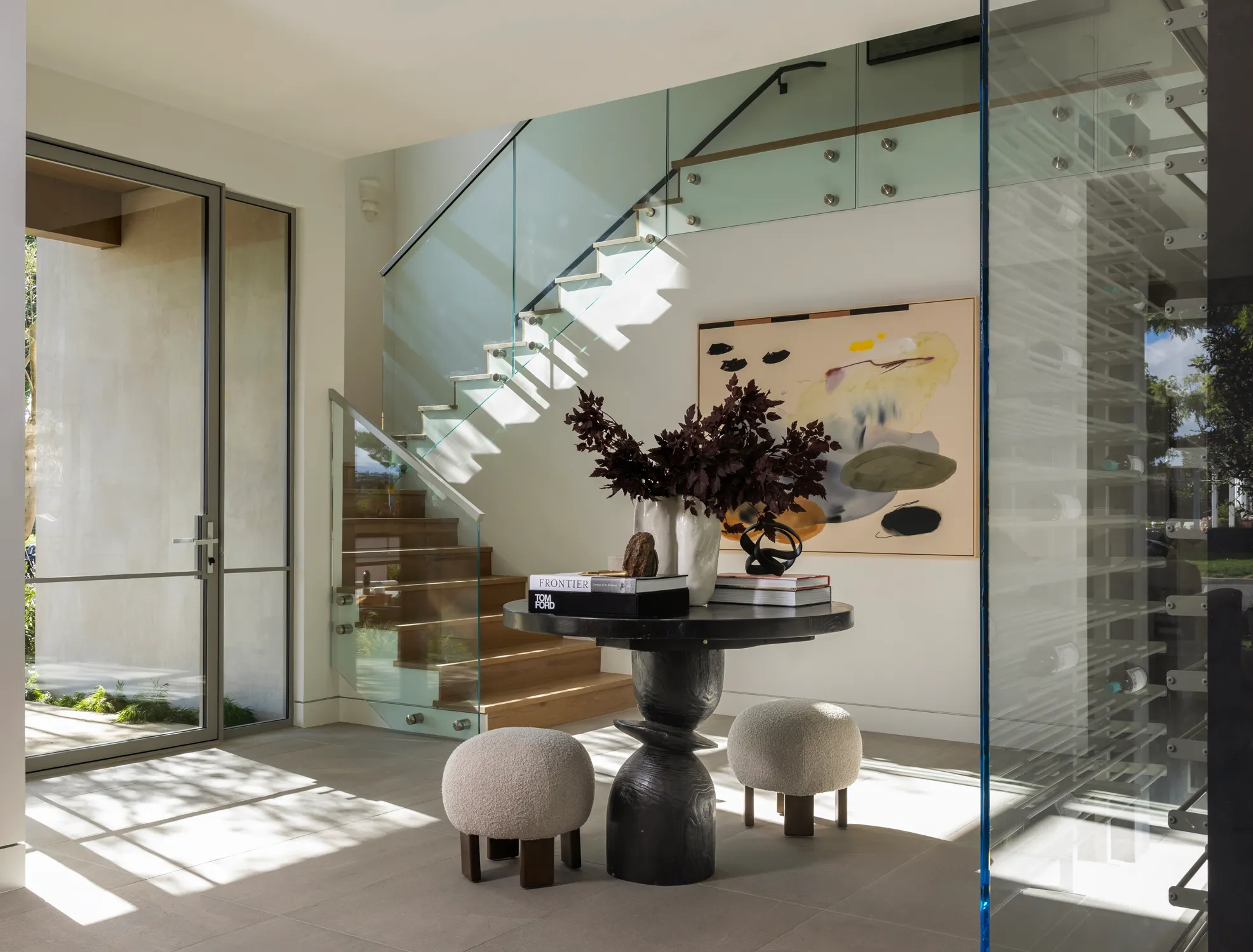 Entry hall with glass staircase and round table