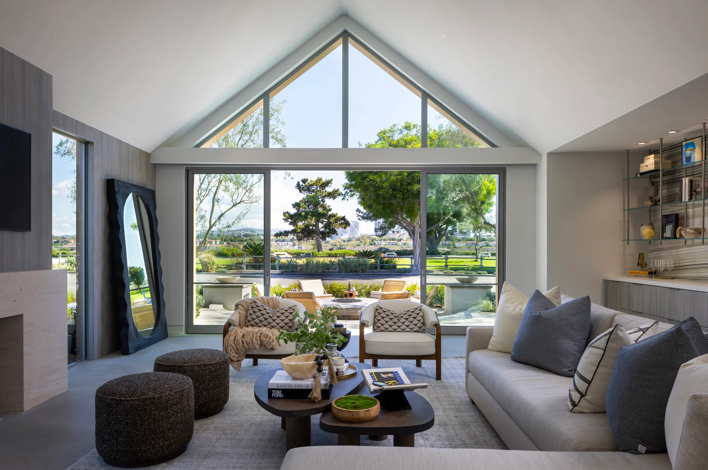 Bright living room with vaulted windows and garden view