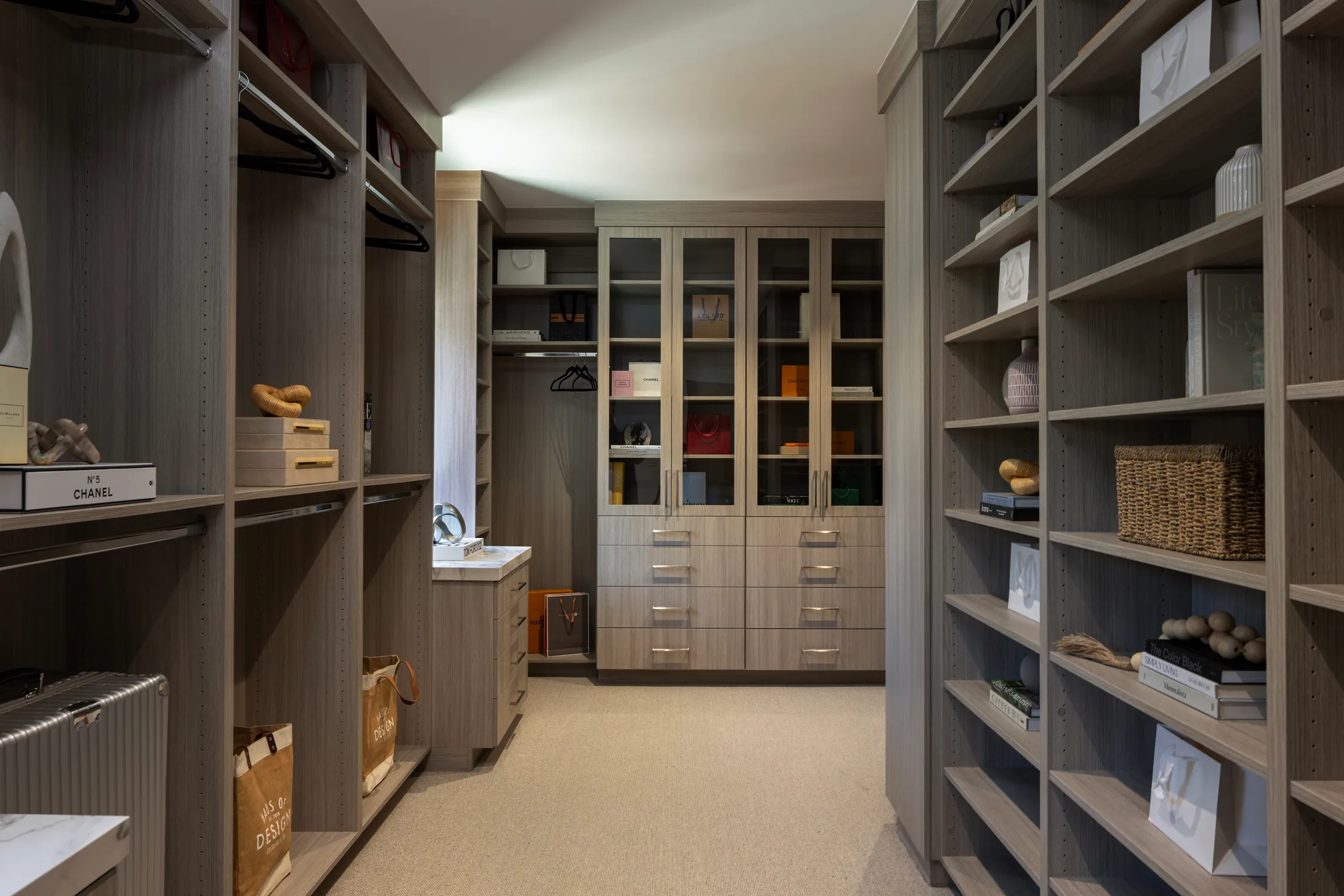 Walk-in closet with dark shelving and center island