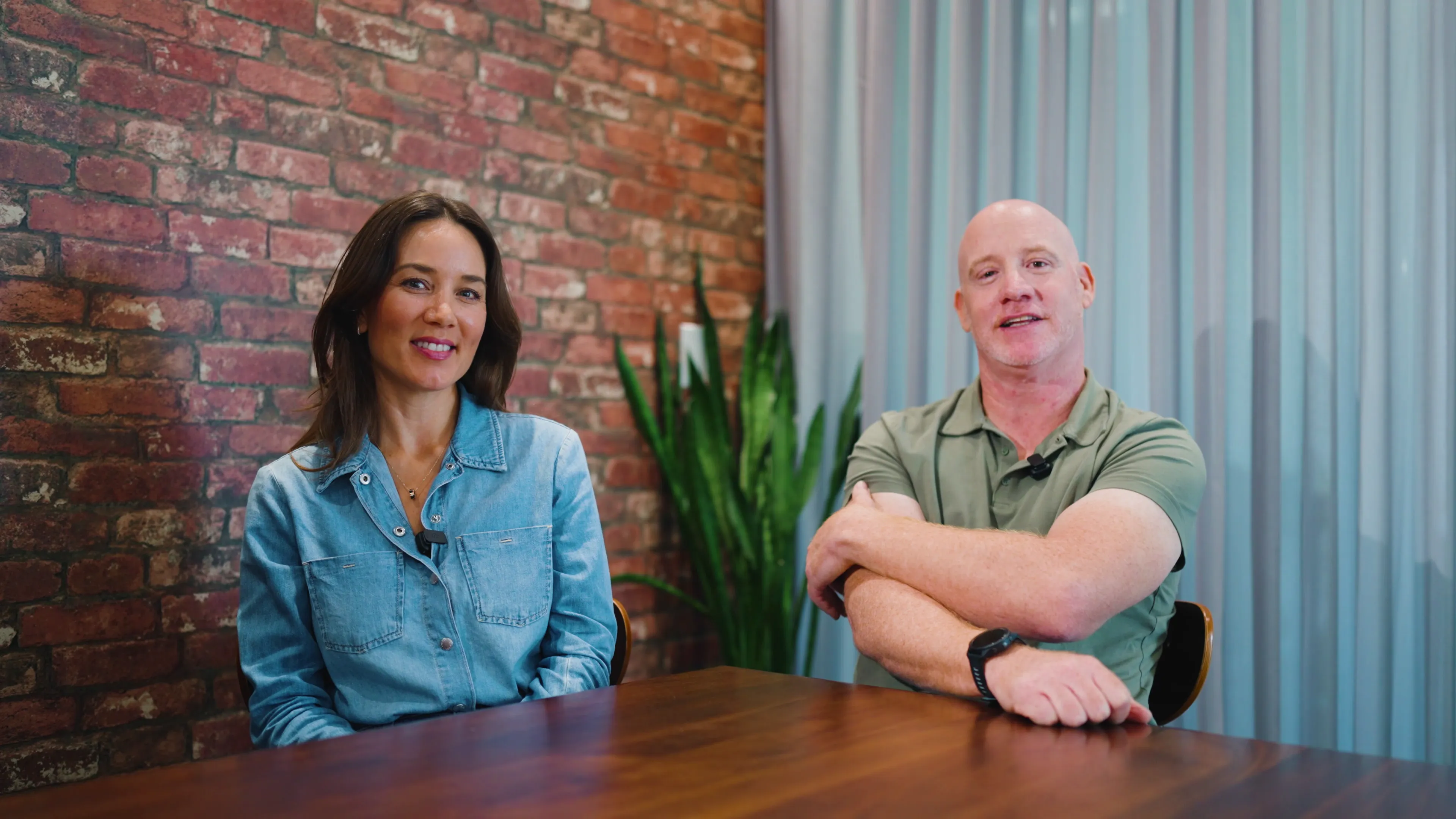 Two people reviewing plans inside a home renovation