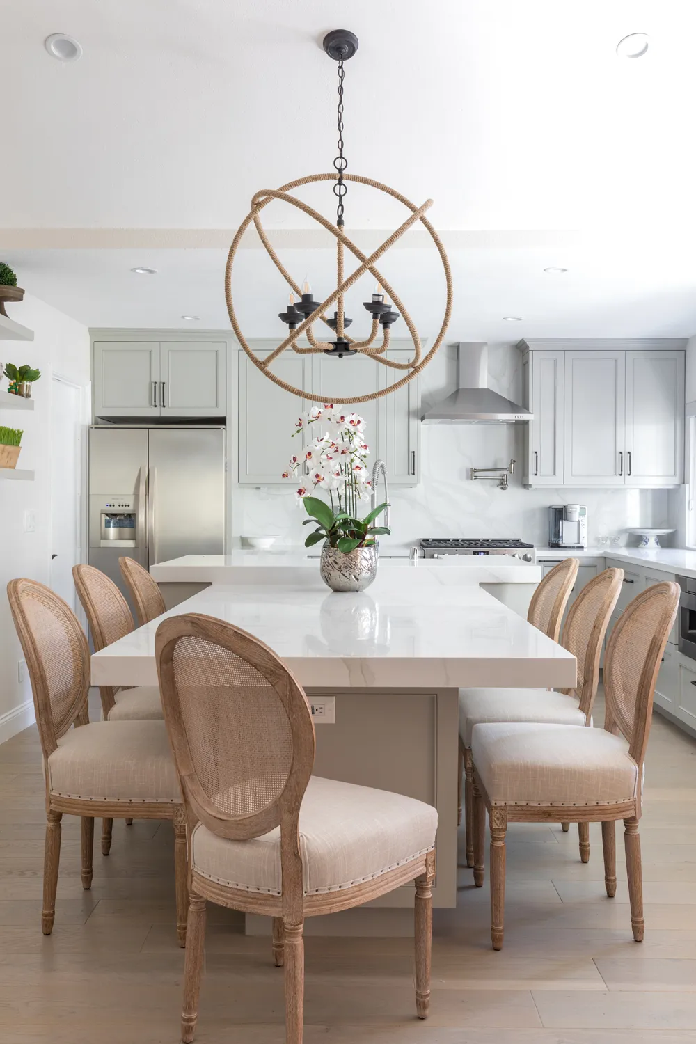 White kitchen island with upholstered dining chairs
