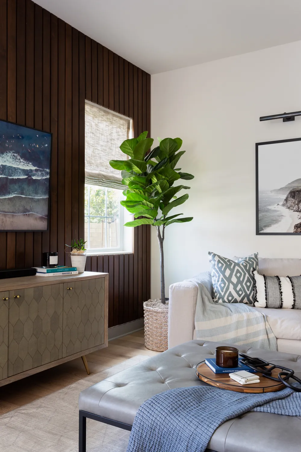 Living room with dark wood accent wall and white sofa