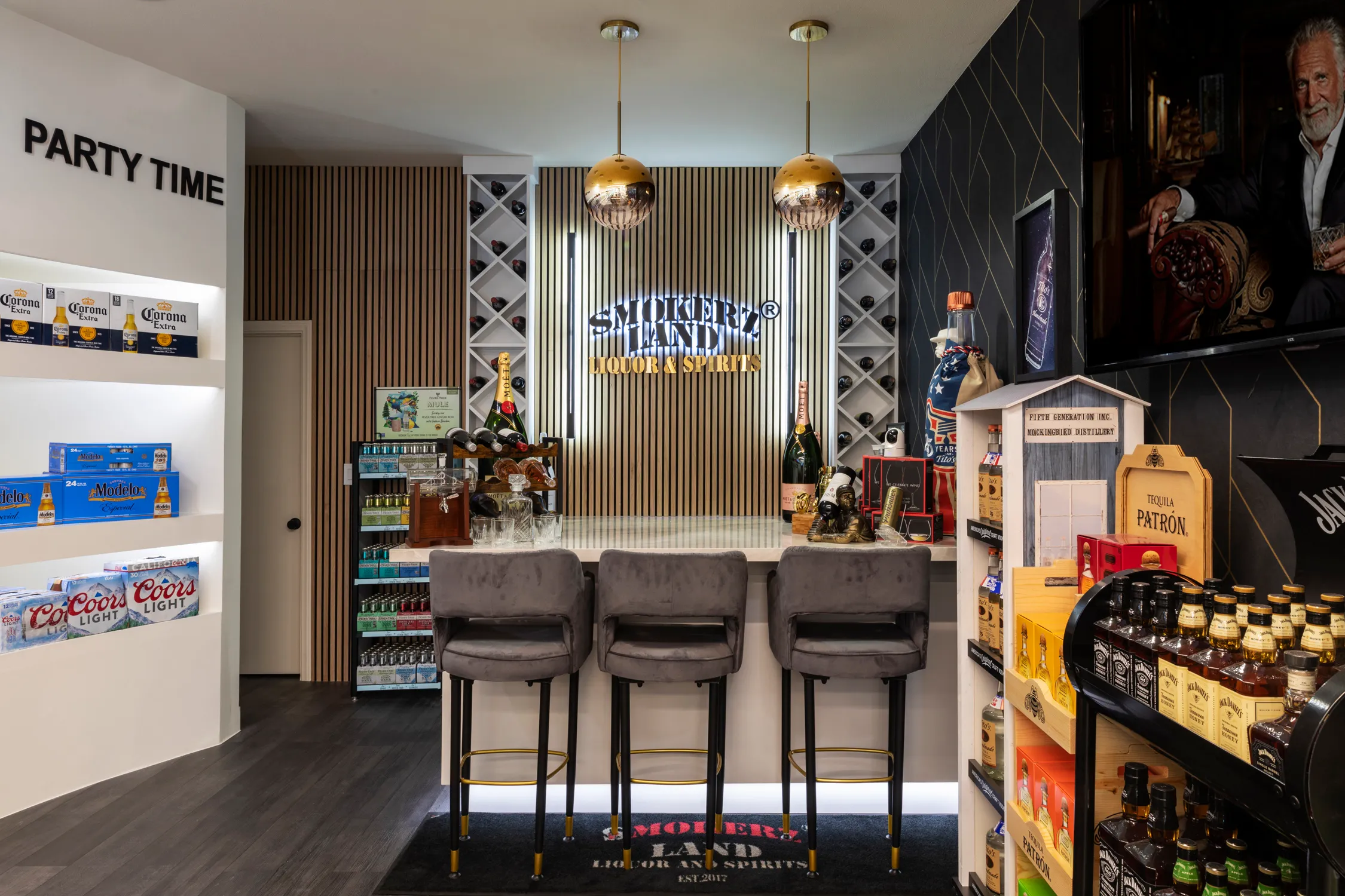 Liquor store tasting counter beneath pendant lights and mural