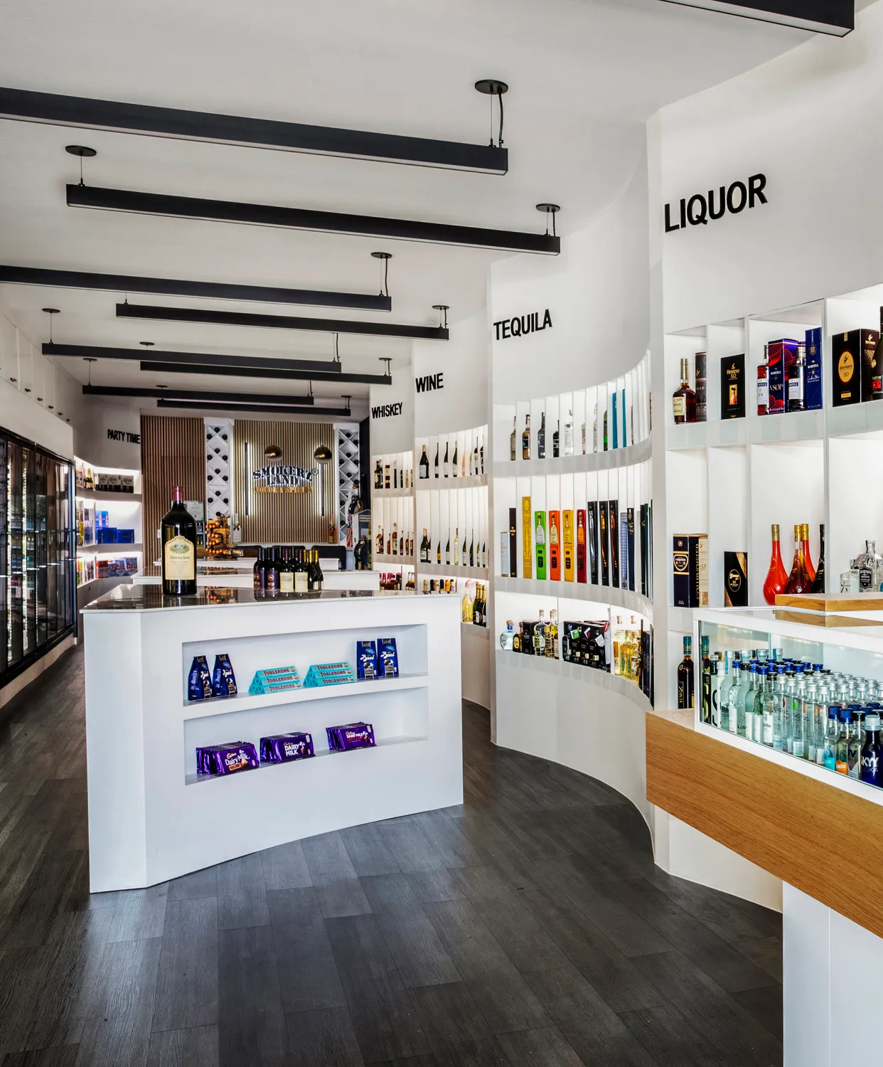 Bright liquor store with curved bottle displays
