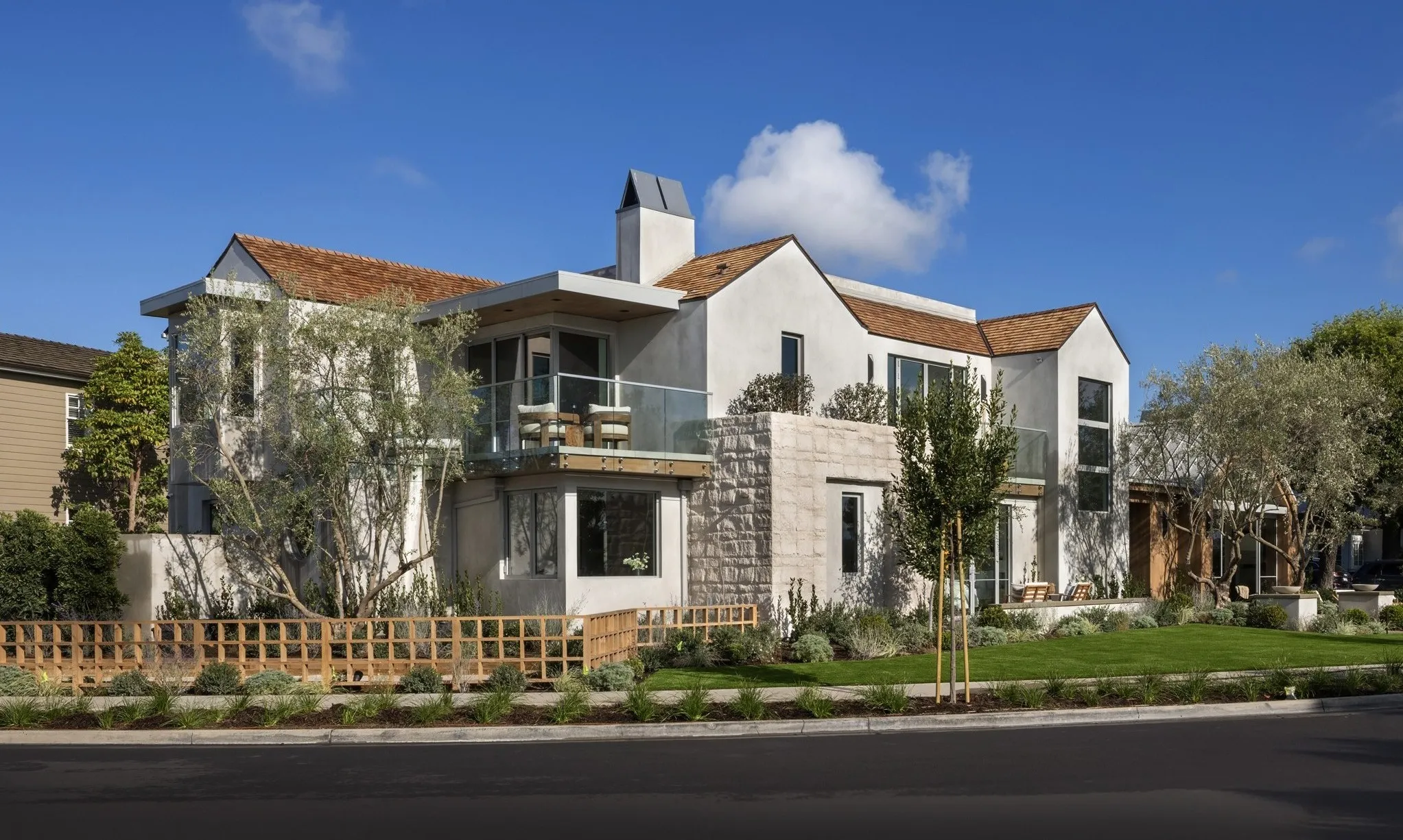 Modern two-story home with stone facade and landscaped front yard