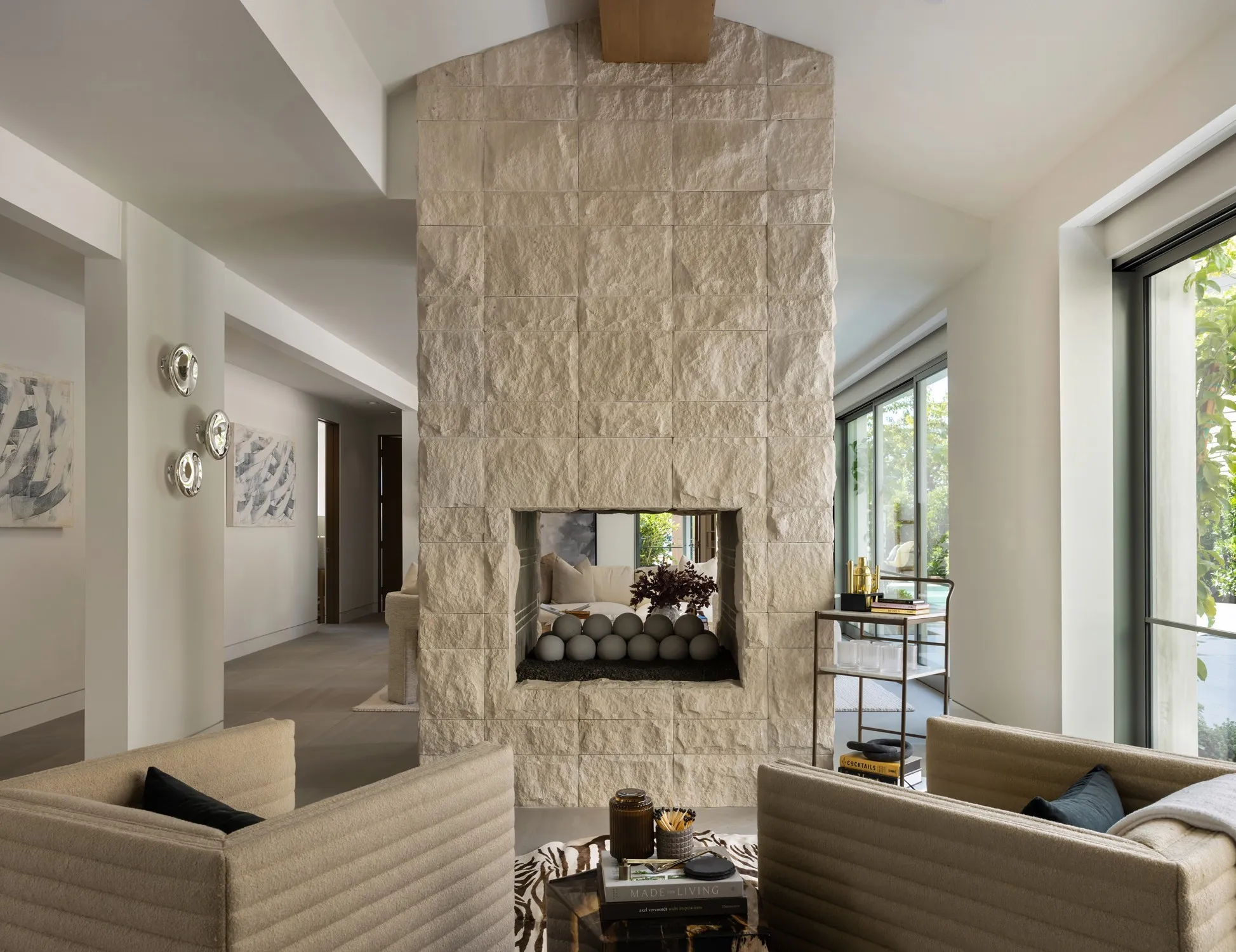 Stone fireplace wall between open living areas
